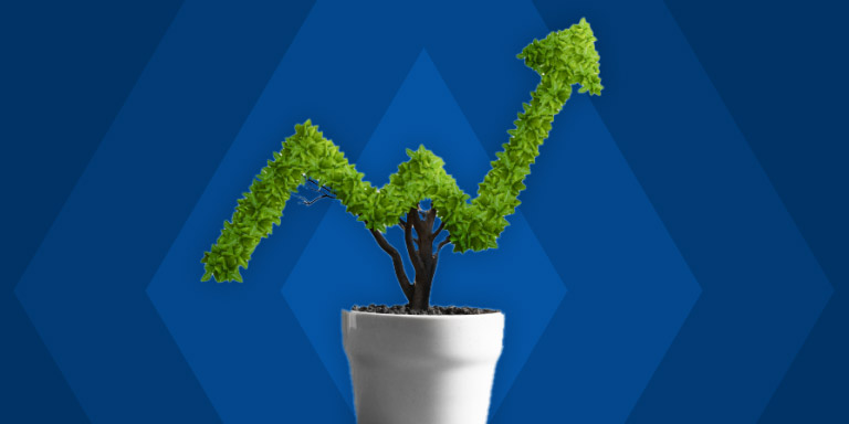 A pot plant tree with leaves formed together in the shape of a line graph arrow indicating stock profit.